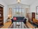 Cozy living room with hardwood floors, large windows, ceiling fan, and comfortable seating arrangement at 2008 Hobbyhorse Ave, Henderson, NV 89012