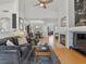 Open-concept living room with fireplace, ceiling fan, and hardwood floors at 2008 Hobbyhorse Ave, Henderson, NV 89012