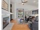 Inviting living room with fireplace, vaulted ceilings, ceiling fan, and sliding doors to backyard at 2008 Hobbyhorse Ave, Henderson, NV 89012