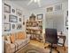 Comfortable home office with a bookshelf, sofa, desk, and plenty of wall art at 2008 Hobbyhorse Ave, Henderson, NV 89012