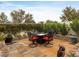 A cozy paver patio with an outdoor fire pit table surrounded by four chairs and manicured landscaping at 2008 Hobbyhorse Ave, Henderson, NV 89012