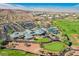 Wide aerial view of a recreation center with lush landscaping, pool, tennis court and parking at 2147 Indigo Creek Ave, Henderson, NV 89012