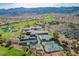 Beautiful aerial view showcasing golf course, community center, tennis courts, swimming pool, and mountains in the background at 2147 Indigo Creek Ave, Henderson, NV 89012