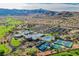 Stunning aerial view showcases the community amenities with a golf course, pool, tennis courts and mountain backdrop at 2147 Indigo Creek Ave, Henderson, NV 89012
