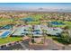 Aerial view of a community recreation center with a pool, tennis courts, and meticulously manicured grounds at 2147 Indigo Creek Ave, Henderson, NV 89012