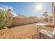 Spacious, low-maintenance backyard featuring desert landscaping, a block wall, and an outdoor seating area at 2147 Indigo Creek Ave, Henderson, NV 89012