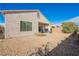 Low-maintenance backyard featuring desert landscaping, a covered patio, and an adjacent block wall at 2147 Indigo Creek Ave, Henderson, NV 89012