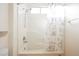 Bright bathroom with a shower featuring white tile and a patterned shower curtain at 2147 Indigo Creek Ave, Henderson, NV 89012
