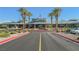 Elegant entrance of the community center featuring palm trees, and landscaped grounds at 2147 Indigo Creek Ave, Henderson, NV 89012