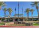 Community Center entrance featuring three flags, stone wall, and landscaping at 2147 Indigo Creek Ave, Henderson, NV 89012