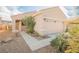 Attractive single-story home featuring a two-car garage, desert landscaping, and a covered front entry at 2147 Indigo Creek Ave, Henderson, NV 89012