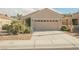 Inviting single-story home with a two-car garage, desert landscaping, and a well-maintained front yard at 2147 Indigo Creek Ave, Henderson, NV 89012