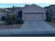 Charming single-story home featuring a two-car garage and desert landscaping at 2147 Indigo Creek Ave, Henderson, NV 89012