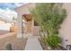 Charming covered front porch with a security screen door and desert-friendly landscaping at 2147 Indigo Creek Ave, Henderson, NV 89012