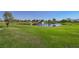 Picturesque golf course with a water feature, manicured green, and mature trees, creating a beautiful landscape for recreation at 2147 Indigo Creek Ave, Henderson, NV 89012