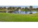 Scenic golf course featuring a serene pond, lush green fairways, and meticulously maintained landscaping, ideal for outdoor leisure at 2147 Indigo Creek Ave, Henderson, NV 89012