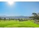 Expansive golf course showcasing rolling green fairways and distant mountains, perfect for outdoor recreation and beautiful scenery at 2147 Indigo Creek Ave, Henderson, NV 89012