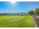 Expansive golf course view showcasing rolling green fairways and distant mountains, perfect for outdoor recreation and scenic beauty at 2147 Indigo Creek Ave, Henderson, NV 89012
