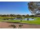 Scenic golf course view showcasing a tranquil pond, lush green fairways, and surrounding mature trees, offering a serene outdoor setting at 2147 Indigo Creek Ave, Henderson, NV 89012