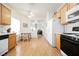 Bright eat-in kitchen featuring modern appliances and light wood cabinets at 2147 Indigo Creek Ave, Henderson, NV 89012