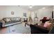 A well-lit living room features multiple couches, a glass coffee table, and elegant decor at 2147 Indigo Creek Ave, Henderson, NV 89012