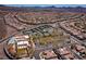 Aerial view of community amenities: pool, clubhouse, tennis courts, and lush landscaping with mountain views at 2151 Bannerwood St, Henderson, NV 89044