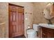 Tiled bathroom featuring toilet and sink with tile floor and walls at 2151 Bannerwood St, Henderson, NV 89044