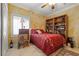 Bright bedroom with yellow walls, a ceiling fan, and an adjacent bookcase at 2151 Bannerwood St, Henderson, NV 89044