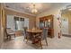 Cozy dining area with a decorative ceiling, chandelier, and a china cabinet at 2151 Bannerwood St, Henderson, NV 89044