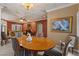 Elegant dining space with marble ceiling, chandelier and a wood dining table at 2151 Bannerwood St, Henderson, NV 89044