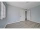 Bedroom featuring light blue walls, light grey wood-look flooring, and two doors at 218 S Bruce St, Las Vegas, NV 89101
