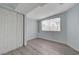 Bedroom featuring light blue walls and light grey wood-look flooring and a double closet at 218 S Bruce St, Las Vegas, NV 89101