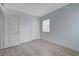 Bedroom featuring light blue walls, light grey wood-look flooring, and two doors at 218 S Bruce St, Las Vegas, NV 89101