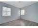 Simple bedroom with light blue walls and two windows to let in lots of light at 218 S Bruce St, Las Vegas, NV 89101