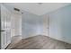 Bedroom features light blue walls, light grey wood-look flooring, and an ensuite at 218 S Bruce St, Las Vegas, NV 89101