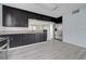 Modern kitchen with stainless steel refrigerator, granite counters, stylish backsplash and gray wood flooring at 218 S Bruce St, Las Vegas, NV 89101