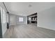 Spacious living room featuring grey wood-look floors, light blue walls and windows for natural light at 218 S Bruce St, Las Vegas, NV 89101