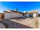 Private backyard with a stone patio, white gravel, and mature landscaping at 2368 Winterwood Blvd, Las Vegas, NV 89142