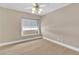 Bedroom featuring neutral walls, hardwood floors, ceiling fan, and window with blinds at 2617 Huber Heights Dr, Las Vegas, NV 89128