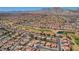 Aerial view shows single-Gathering homes within a community bordering the golf course against a desert mountain backdrop at 3012 Anna Bay Dr, Las Vegas, NV 89134