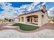 View of the home's backyard featuring beautiful landscaping and a covered patio at 3012 Anna Bay Dr, Las Vegas, NV 89134