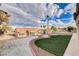 Landscaped backyard with mature plants, privacy walls, and artificial turf at 3012 Anna Bay Dr, Las Vegas, NV 89134