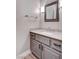Powder room with gray vanity, stone countertop, and modern fixtures, creating a contemporary aesthetic at 3012 Anna Bay Dr, Las Vegas, NV 89134