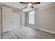 Bedroom featuring light gray walls, wood-look floors, closet with paneled doors, and a ceiling fan at 3012 Anna Bay Dr, Las Vegas, NV 89134