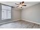 Bright bedroom featuring light gray walls, wood-look floors, and a ceiling fan at 3012 Anna Bay Dr, Las Vegas, NV 89134