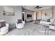 Staged bedroom with neutral color palette, ceiling fan, and wood-look flooring at 3012 Anna Bay Dr, Las Vegas, NV 89134