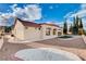 A well-maintained backyard with decorative gravel, manicured lawn, and stucco walls at 3012 Anna Bay Dr, Las Vegas, NV 89134