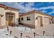 Beige home with a red tile roof and a three car garage with a concrete driveway and desert landscaping at 3012 Anna Bay Dr, Las Vegas, NV 89134