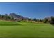 Scenic golf course with a blue flag, mountain backdrop, and desert landscape at 3012 Anna Bay Dr, Las Vegas, NV 89134