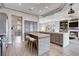 Open-concept kitchen featuring an island with seating flowing into the living area at 3012 Anna Bay Dr, Las Vegas, NV 89134